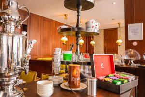 a kitchen with a counter top with a table with a blender at Hotel Kaspar Garni in Siegburg