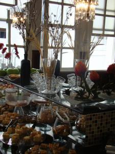 a table filled with lots of different types of food at Brasil Palace Hotel in Belo Horizonte