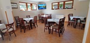 a dining room with tables and chairs in a restaurant at Willa Salamandra in Krynica Zdrój