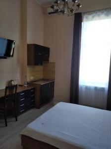 a bedroom with a bed and a tv at Best Season Apart Hotel in Kyiv