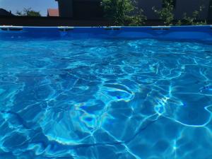 a blue swimming pool with blue water at Vila melek 4 bedrooms in Sarajevo