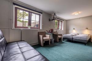 a hotel room with two beds and a desk at B&B Rehoboth in Domburg