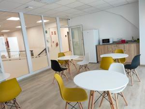 a conference room with tables and chairs in an office at Las Huertas in La Penilla