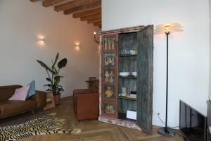 a living room with a large wooden book case at 't hart van Schiedam in Schiedam