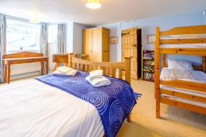 a bedroom with two beds and a bunk bed at Gunfleet, Aldeburgh - A Large Seafront House with Stunning Sea Views from all the floors, Sleeps 14 - Aldeburgh Coastal Cottages in Aldeburgh +44 photos
