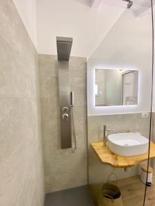 a bathroom with a sink and a mirror at B&B Anastasia in Santa Teresa Gallura
