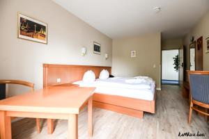 Postel nebo postele na pokoji v ubytování Hotel Blutenburg