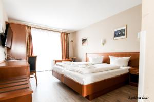 Postel nebo postele na pokoji v ubytování Hotel Blutenburg