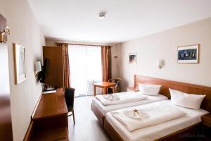 Postel nebo postele na pokoji v ubytování Hotel Blutenburg