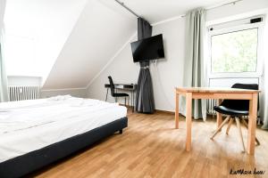 Postel nebo postele na pokoji v ubytování Hotel Blutenburg