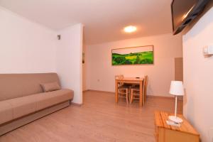 a living room with a couch and a table at Guesthouse Les in Brežice