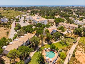 an aerial view of a resort with a pool and trees at Vale d'El Rei Hotel & Villas in Carvoeiro