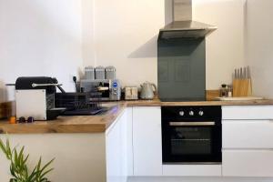 a kitchen with a black and white stove top oven at Modern 1 Bedroom Apartment, Close to the Beach with Parking in Bournemouth