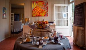 a table with a bowl of fruit on it at La Maison Douce in Saint-Martin-de-Ré +85 photos