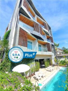 a hotel with a swimming pool and a resort sign at Lemonade Phuket Hotel -SHA Plus in Chalong