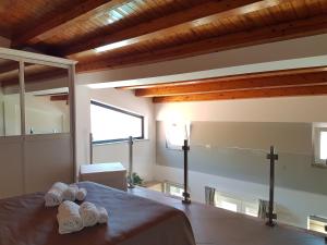 a bedroom with a bed with two pairs of slippers at Villa Glamour in Taormina