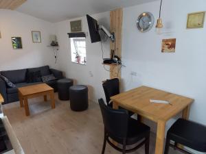 a living room with a table and a couch at Lyngsågaard H in Sæby
