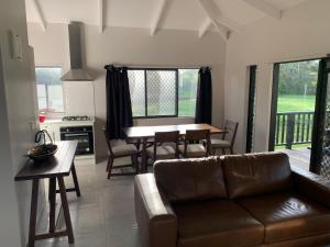 a living room with a couch and a table at Kaia Villas in Rarotonga