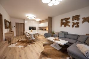 a living room with a couch and a table at Apartmány Kaskády Luhačovice in Luhačovice