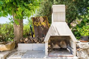 a wood fired pizza oven in a garden at House Kočan in Gruda