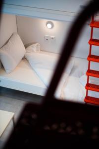 a small room with a bed and a ladder at You Hotels Deauville - Handwritten Collection in Deauville
