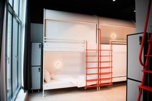 a room with a bunk bed with a ladder at You Hotels Deauville - Handwritten Collection in Deauville
