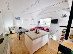 a living room with a kitchen and a dining room at Quirky Seaside Family Cottage walk to the waves! in Brighton & Hove