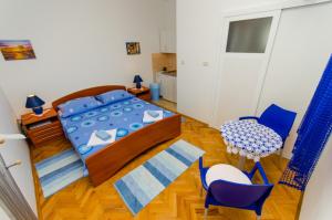 a bedroom with a bed and a table and chairs at Apartments Ivana in Trogir
