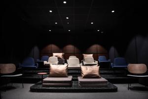 a waiting room with chairs and pillows at You Hotels Deauville - Handwritten Collection in Deauville
