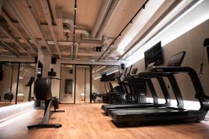 a gym with treadmills and elliptical machines at You Hotels Deauville - Handwritten Collection in Deauville