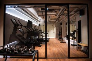 a gym with treadmills and elliptical machines at YOU Are Deauville in Deauville