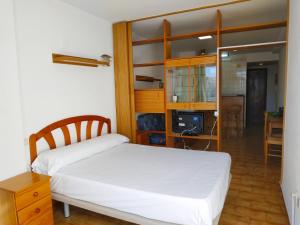 a bedroom with a white bed and a desk at PeñiscolaPlaya Orangecosta in Peniscola +9 photos