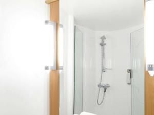 a bathroom with a shower with a glass door at Ibis Styles Liverpool Centre Dale Street - Cavern Quarter in Liverpool