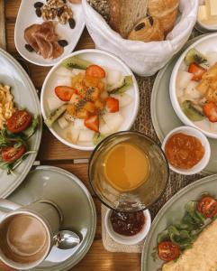 a table with plates of food and a cup of coffee at Can Alberti 1740 Boutique Hotel in Mahón