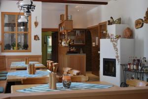 a dining room with two tables and a fireplace at Wirtshaus Birkenhof in Weißenstadt