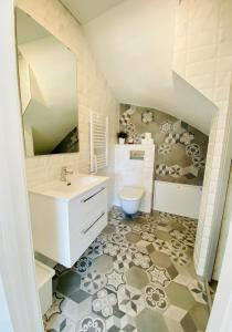 a bathroom with a sink and a toilet at KoKo House Palanga in Palanga