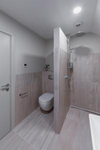 a bathroom with a toilet and a shower at Park Hotel Šiauliai in Šiauliai