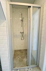 a shower with a glass door in a bathroom at KoKo House Palanga in Palanga