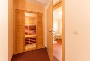 a bathroom with a closet and a toilet in a room at Hotel Starchlhof in Schladming +43 photos