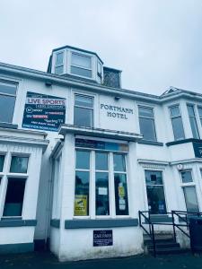 un edificio blanco con un hotel de pingüinos en The Portmann Hotel en Kilmarnock