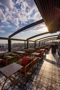 a restaurant with tables and chairs on top of a building at Grand Balyan Hotel & Restaurant in Istanbul