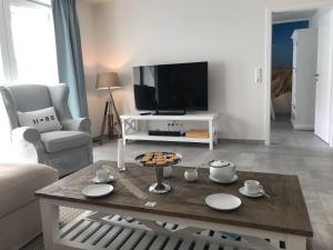 un soggiorno con tavolino e TV di OceanView a Wittdün