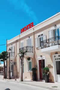 a hotel with a sign on top of it at Hotel Kyani Akti in Xylokastro