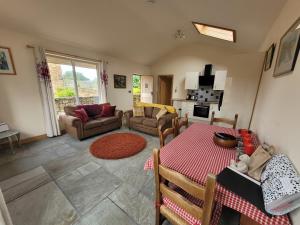 a living room with a table and a fireplace at Swallow cottage, Over Kellet in Over Kellet