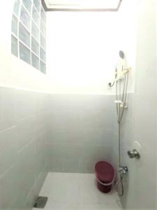 a bathroom with a toilet with a purple seat at Gaea's Apartments in Panglao Island