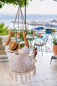 a woman laying in a hammock on a patio at Apartment TOP TERRACE in Podgora