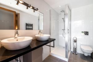 a bathroom with two sinks and a shower at AUx SPORTS D HIVER in Courchevel