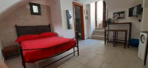 1 dormitorio con 1 cama roja en una habitación en La casetta nel claustro 2, en Altamura