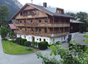 een groot houten huis met veel ramen bij Landhaus Eberler in Mayrhofen