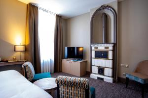 a hotel room with a bed and a tv at Hôtel Spa Marotte in Amiens +79 photos